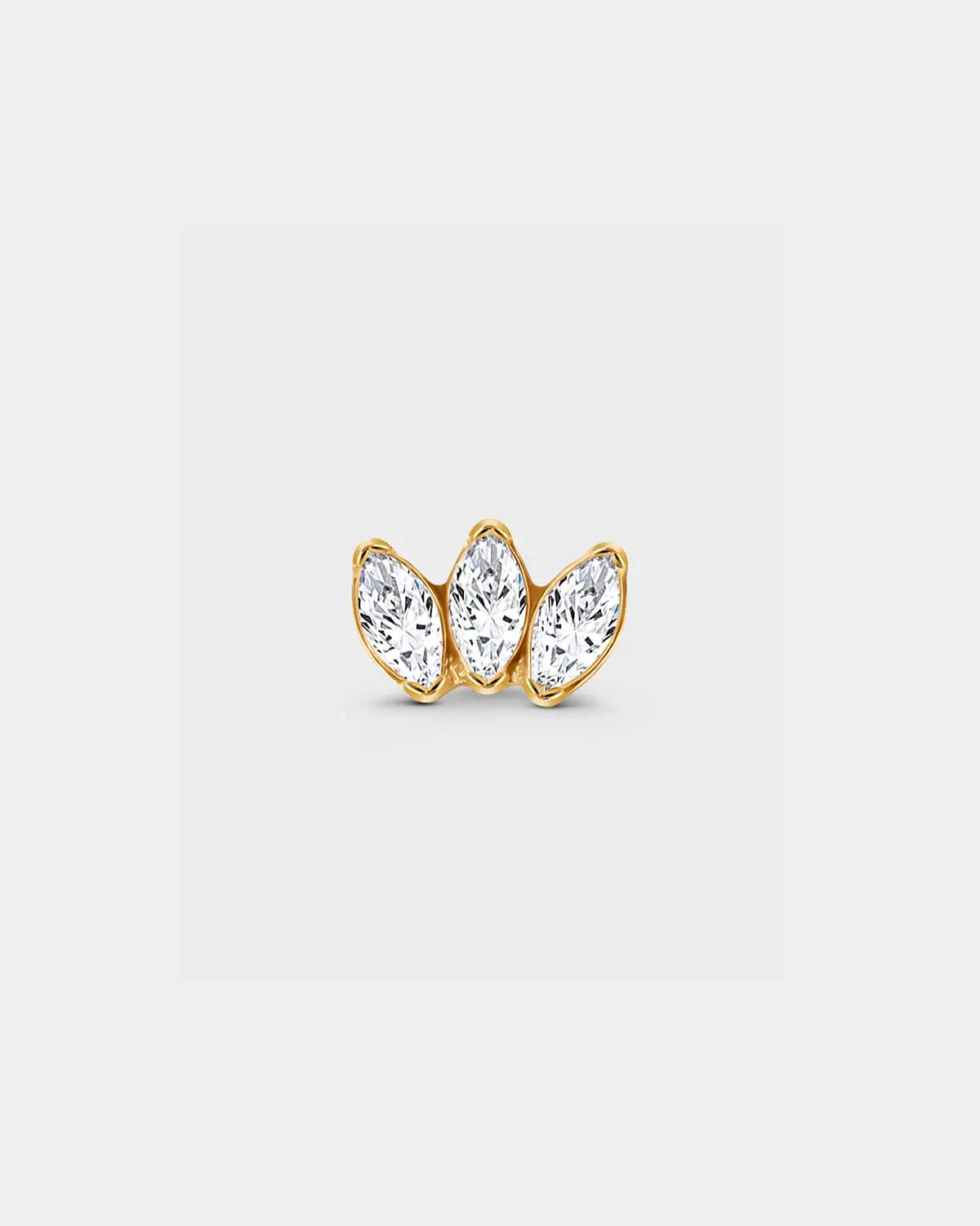 Gold titanium threadless earring with three bezel set clear marquise gemstone in a slight fan shape in a light grey background.