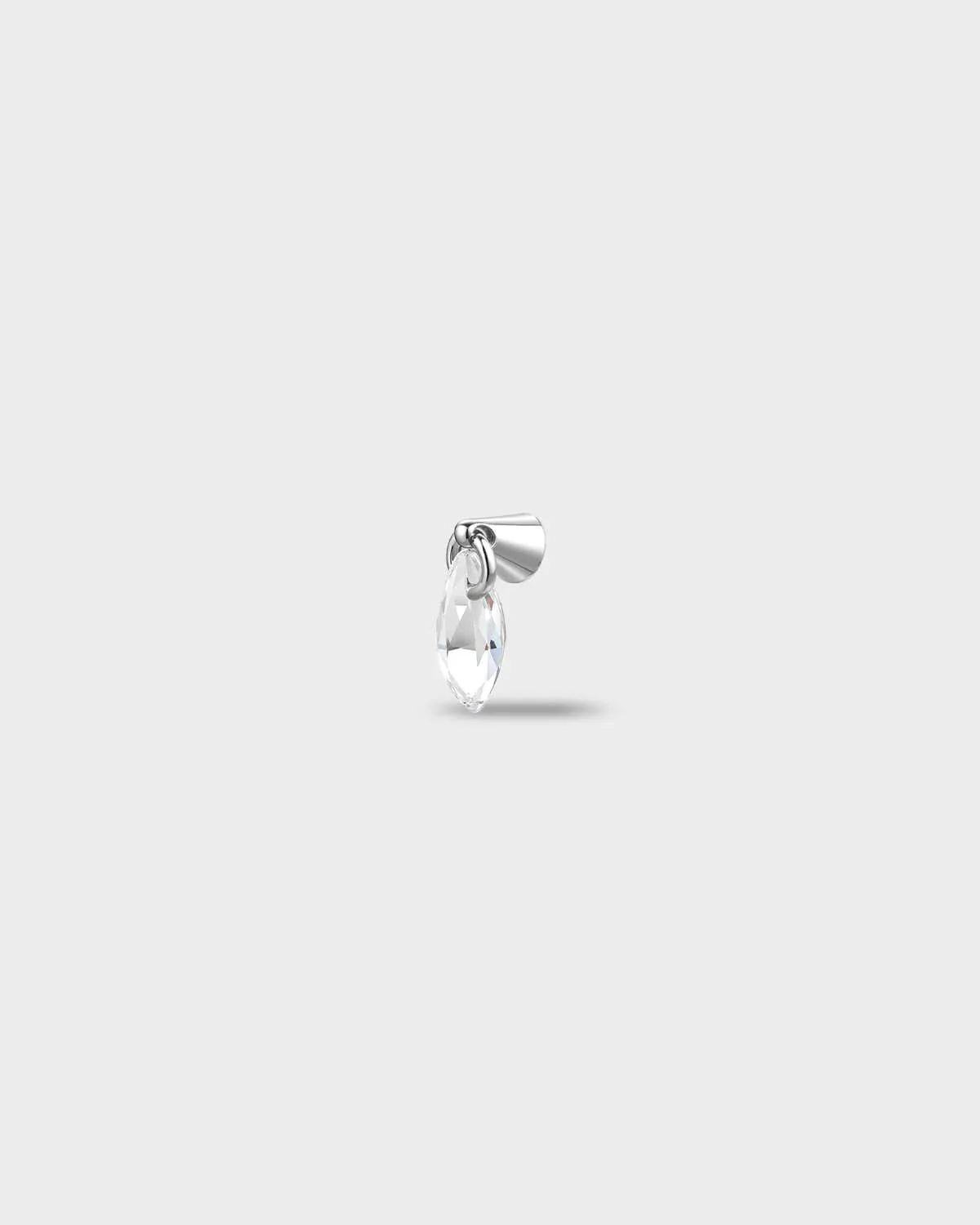 Polished titanium earring with a marquise-cut clear stone suspended from a smooth, tapered setting, on a light gray background.