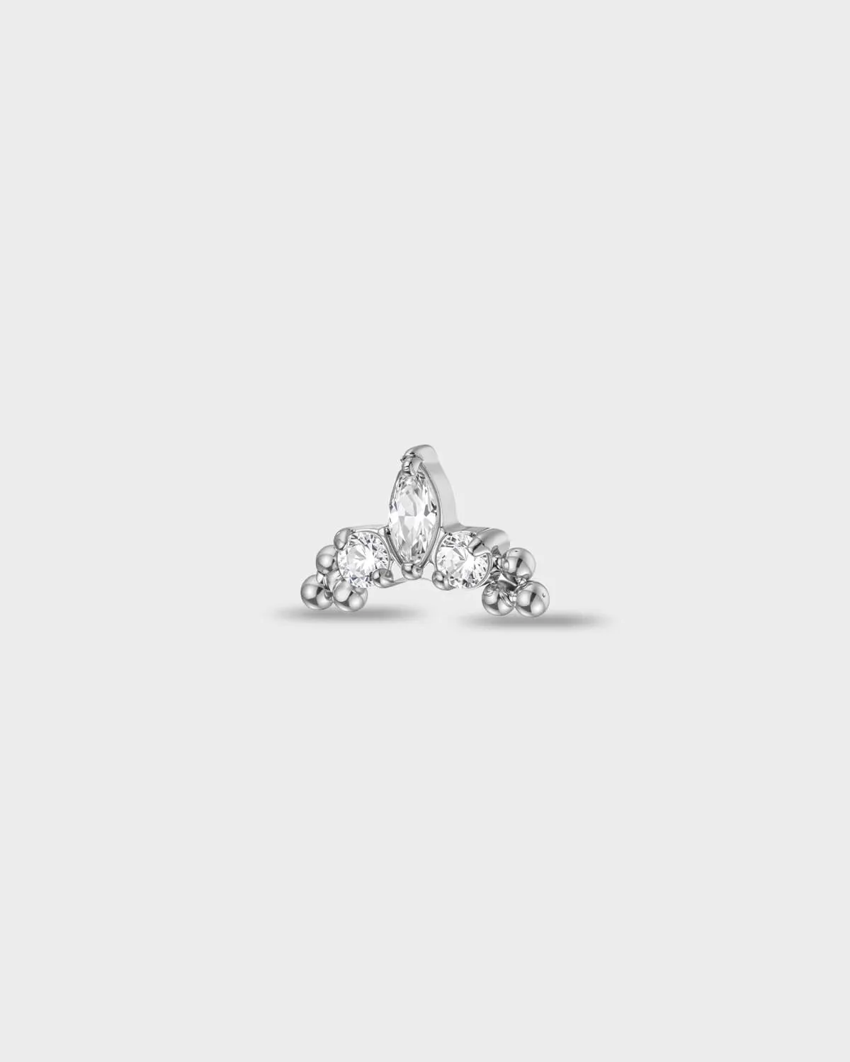 Polished titanium earring with a marquise-cut clear stone set between two round-cut clear stones, finished with polished bead details at each side, on a light gray background.