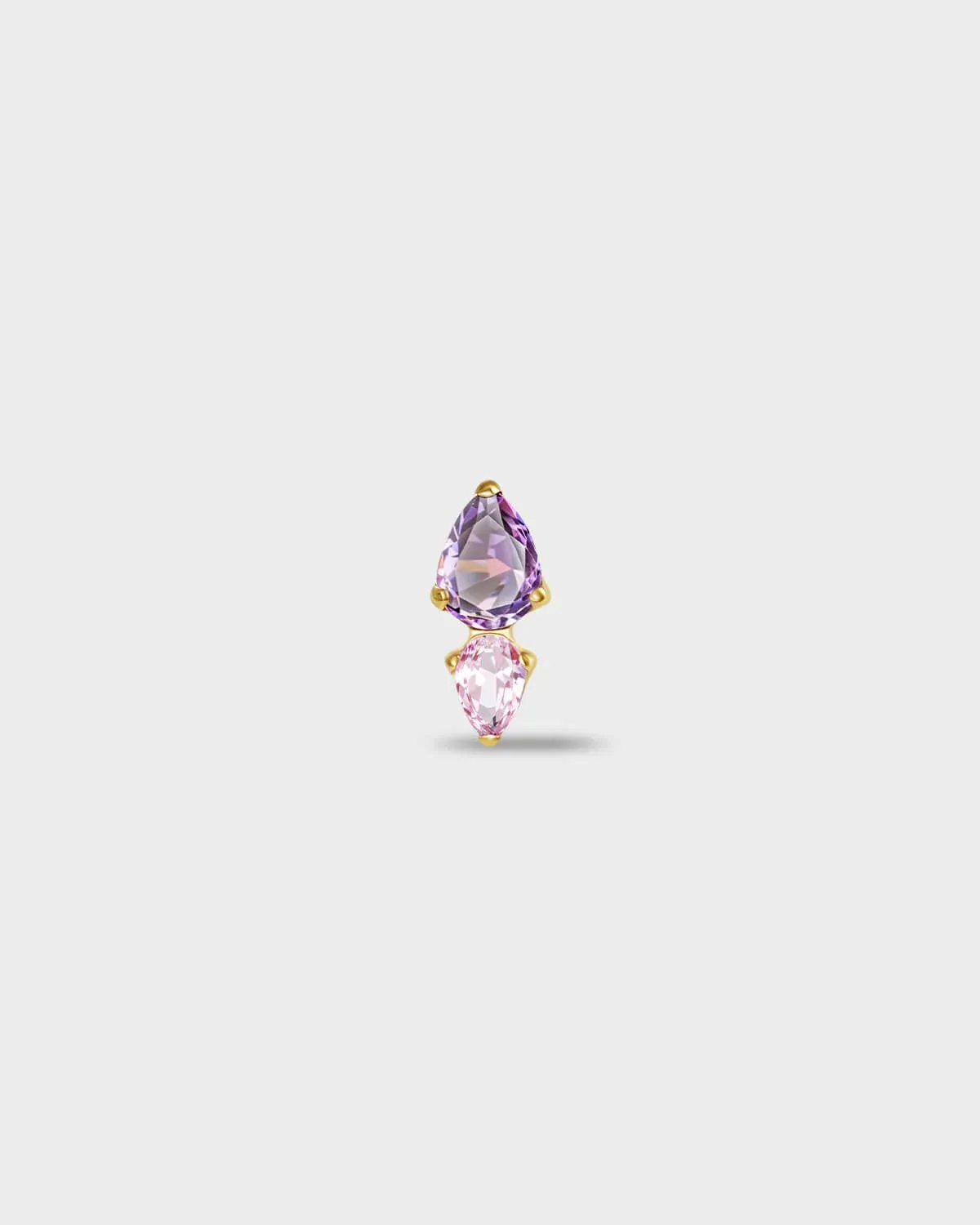 Gold titanium earring with a pear-cut purple stone set above a smaller pear-cut pale pink stone on a light gray background.
