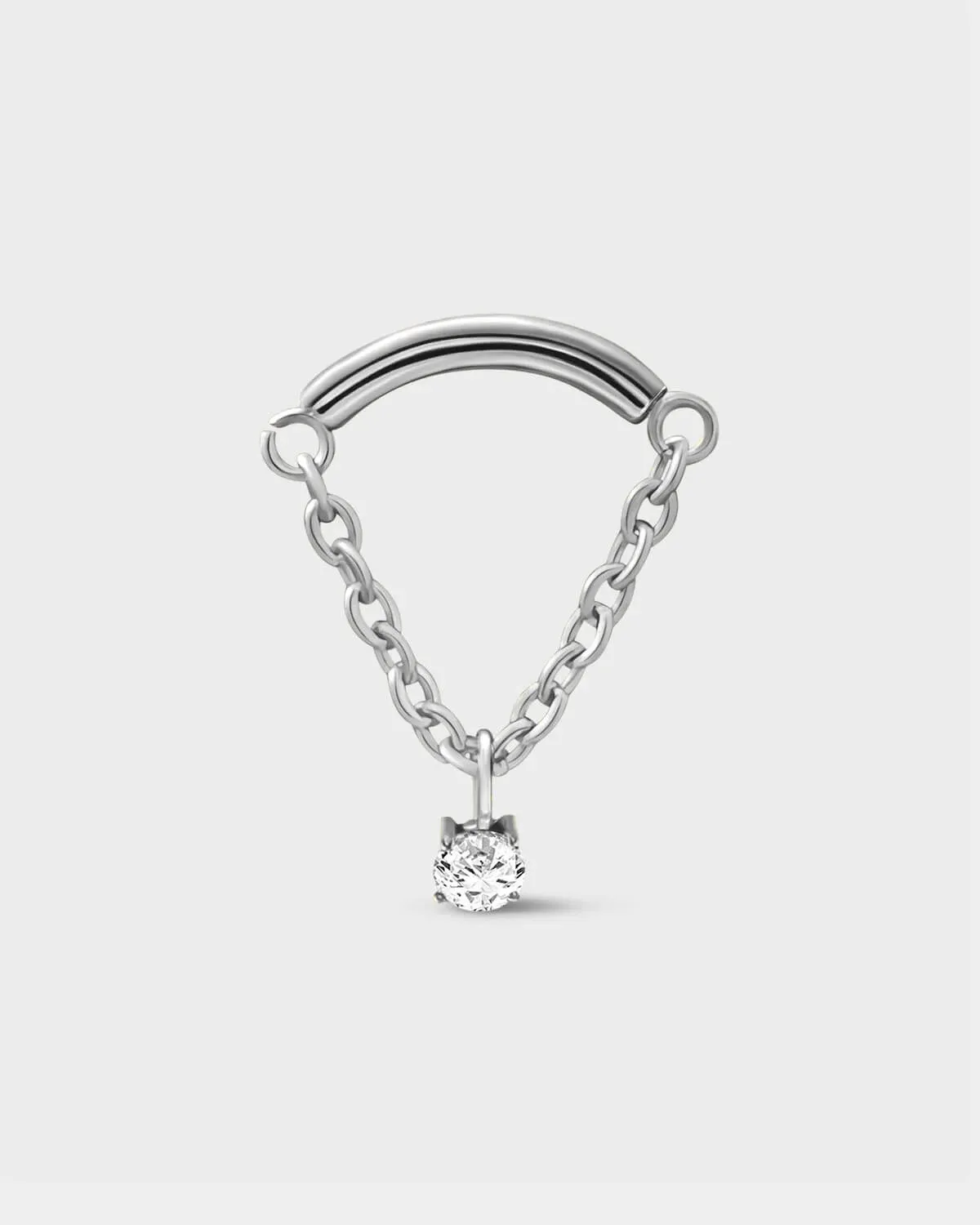 Polished silver titanium earring used for hidden helix or hidden rook featuring a smooth curved bar with a chain connected at each end and a single clear solitaire pendent on a light grey background.