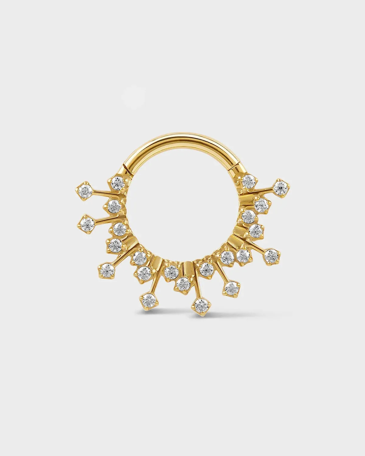 Gold titanium daith septum ring with small gramstones on a light gray background