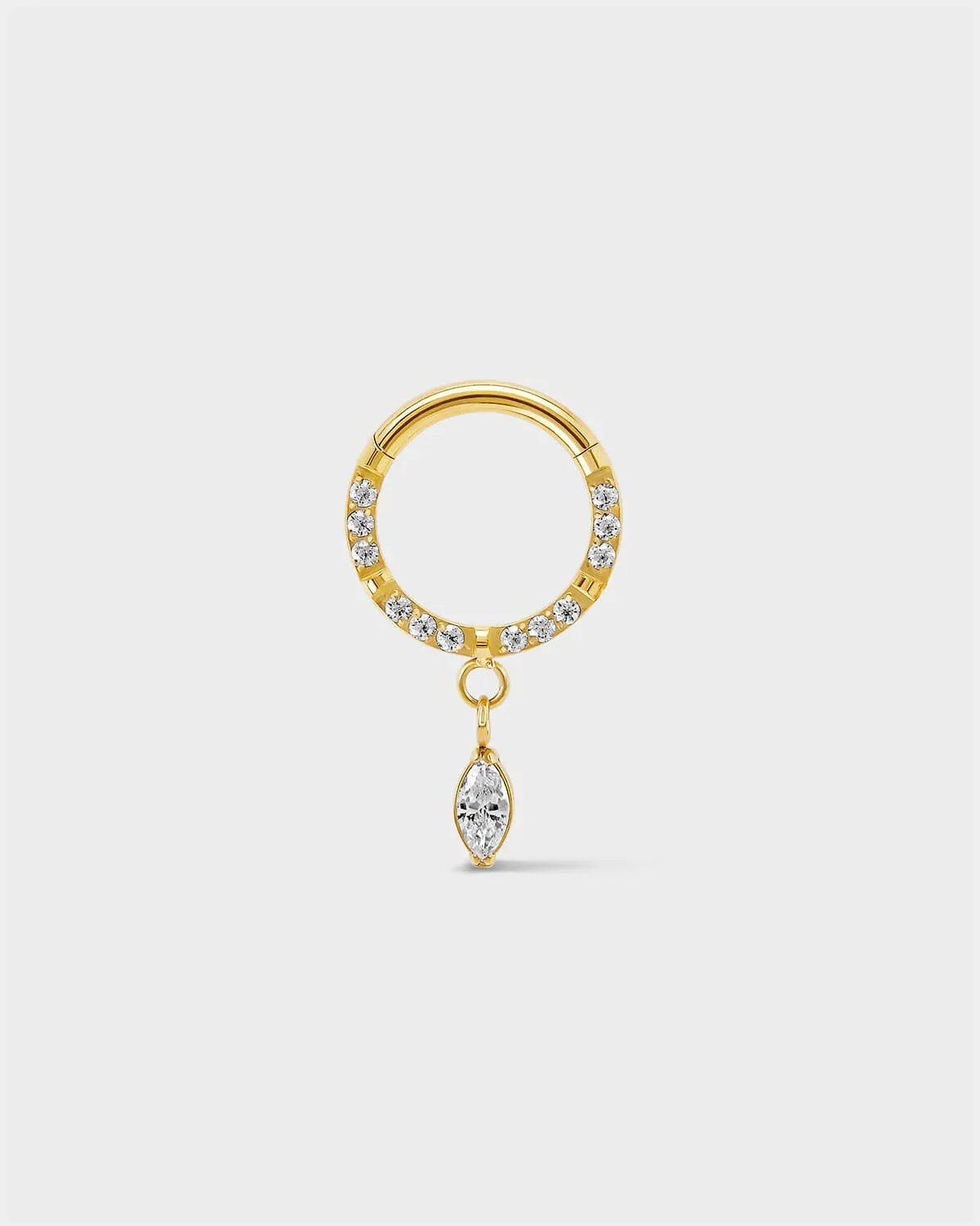 Semi pave gold titanium daith septum ring with a marquise dangle charm sat on a light gray background.