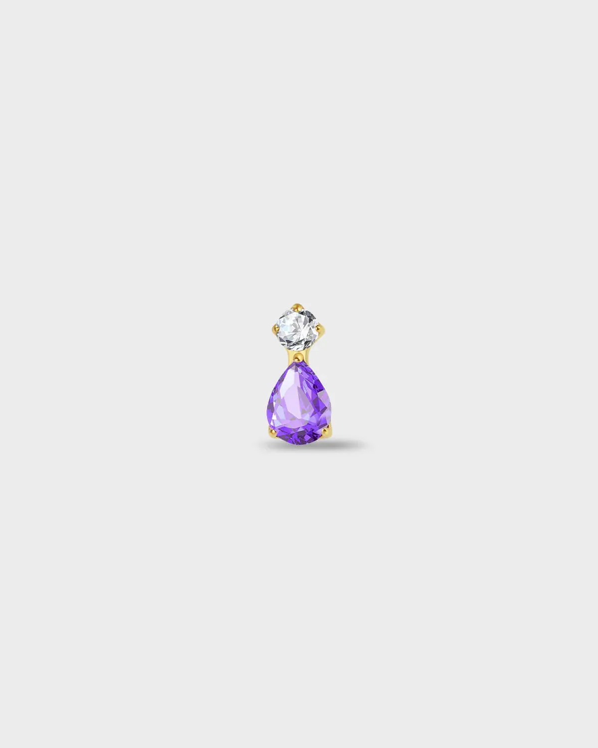 Gold titanium earring with a round-cut clear stone set above a pear-cut amethyst purple stone on a light gray background.