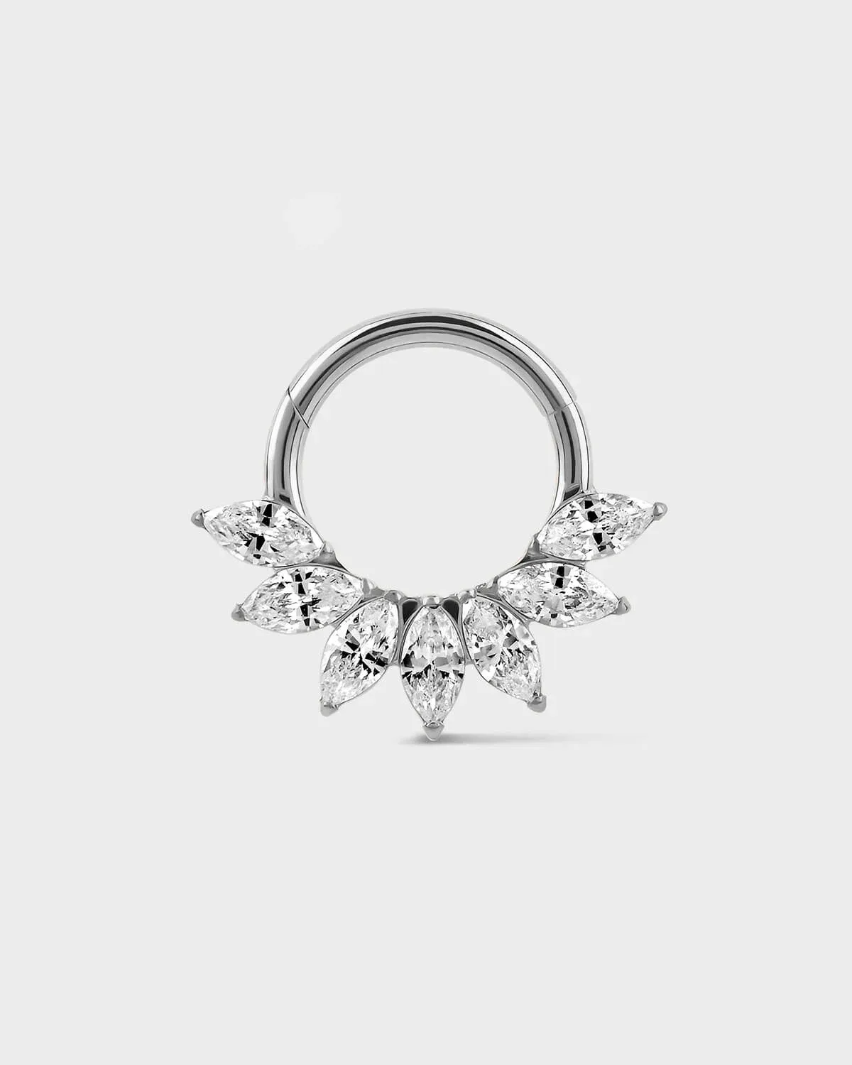 Daith Septum ring in polished titanium with seven marquise gemstone in a fan formation on a light gray background
