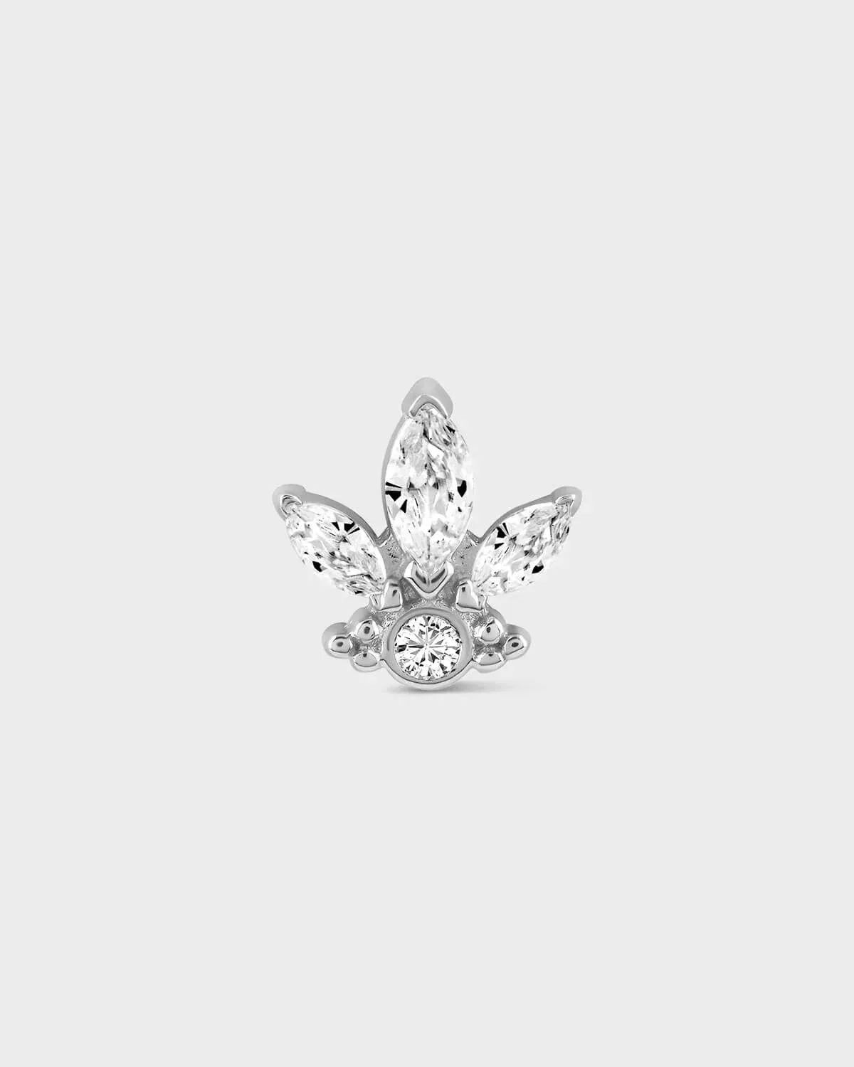 Butterfly-shaped earring with clear gemstones on a light gray background