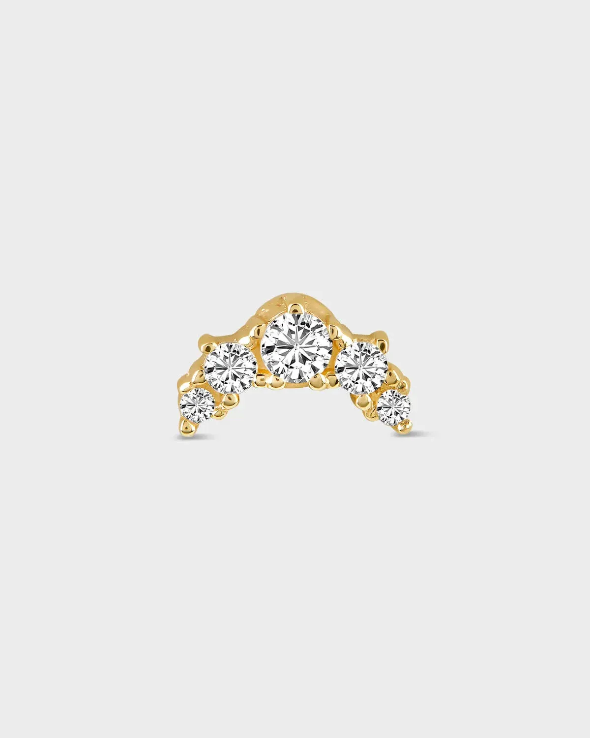 Gold earring with five diamonds on a light gray background