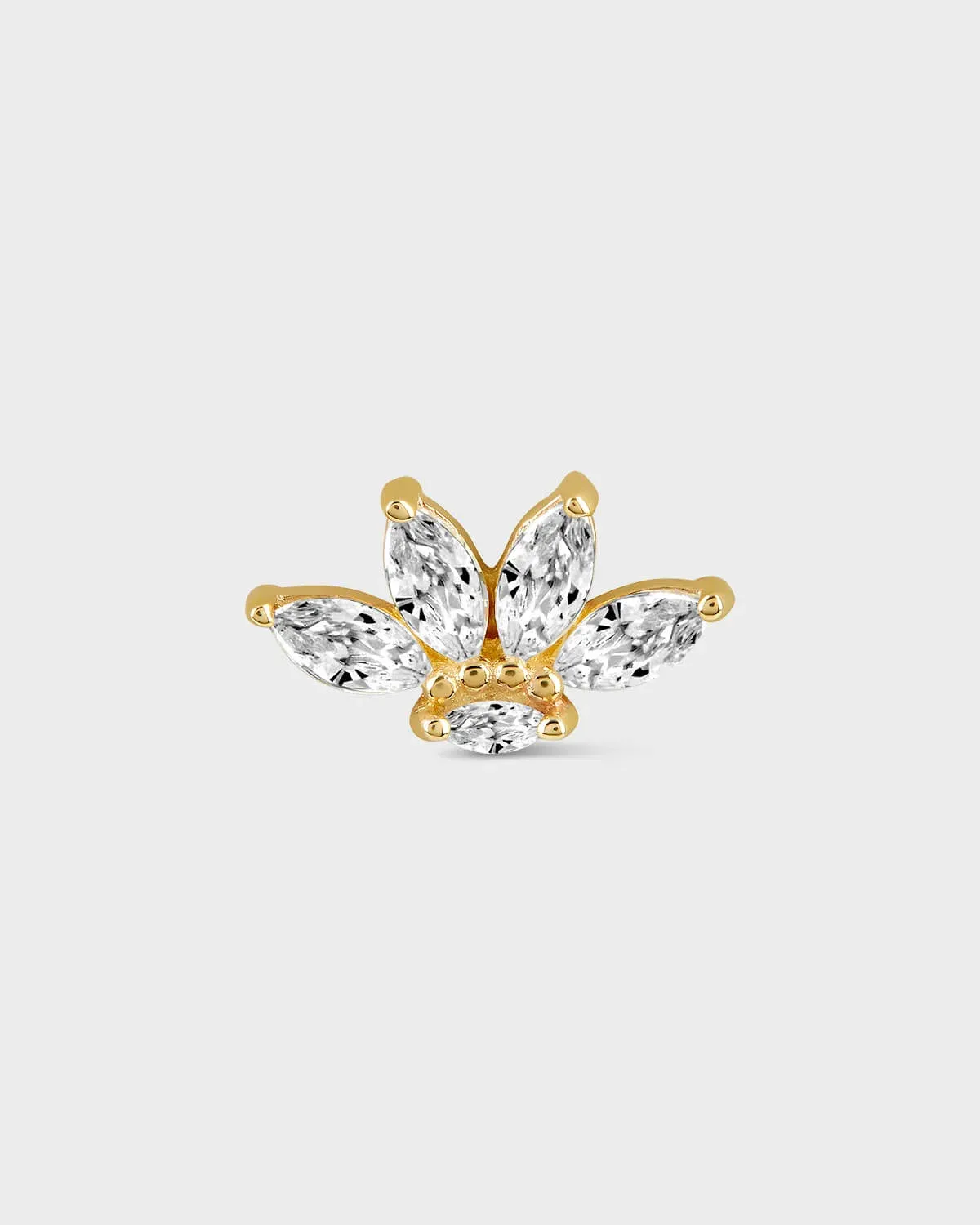 Shaped earring with clear gemstones on a light gray background