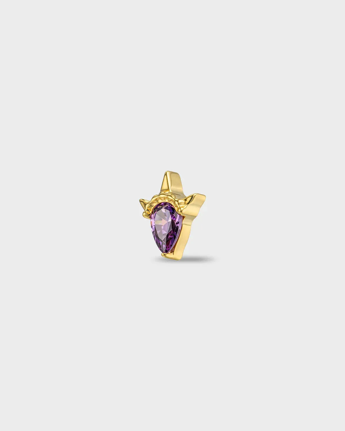Gold titanium earring with a pear-cut amathyst purple stone set in a sculpted, pointed setting, on a light gray backgroud.