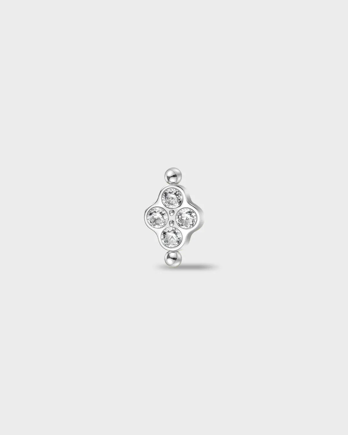 Polished titanium earring with four round-cut clear stones set in a compact cluster, finished with polished bead details at the top and bottom, on a light gray background.