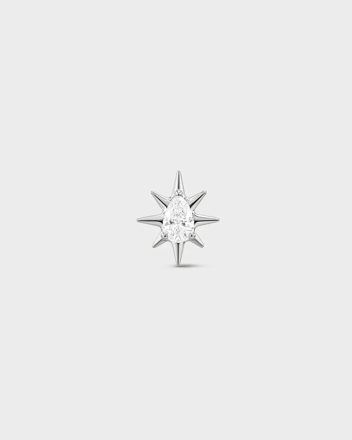 Polished silver titanium threadless end with a marquise-cut clear stone set within a sculpted starburst design. On a light grey background.