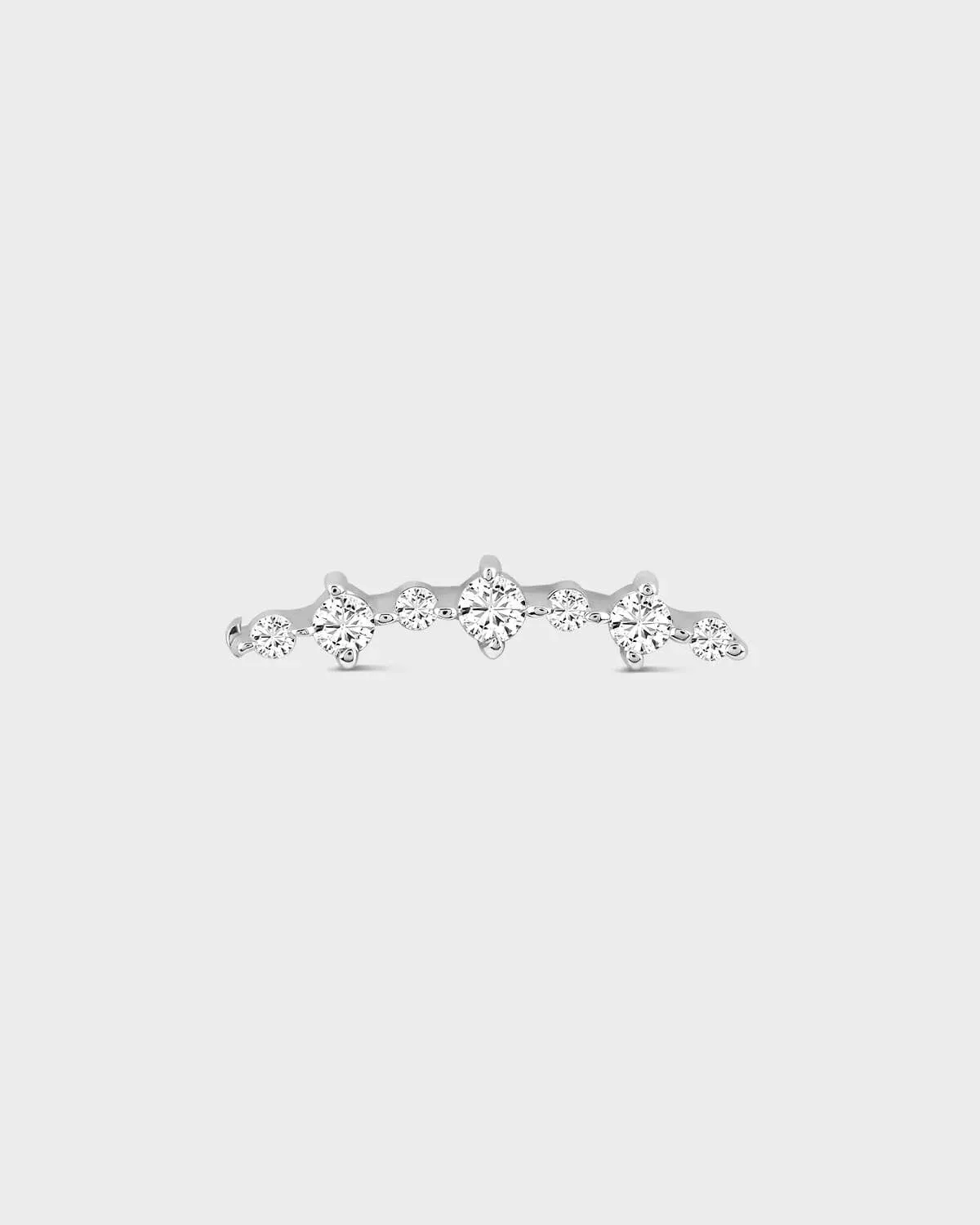 Silver earring with multiple diamonds on a light gray background