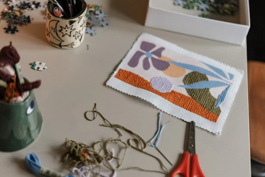 A table topped with a pair of scissors and a picture