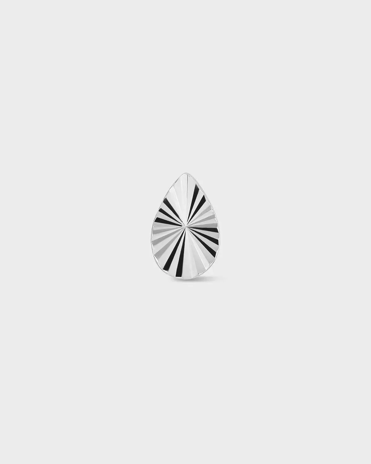 Teardrop-shaped silver ring with lazer cut pattern on a light gray background