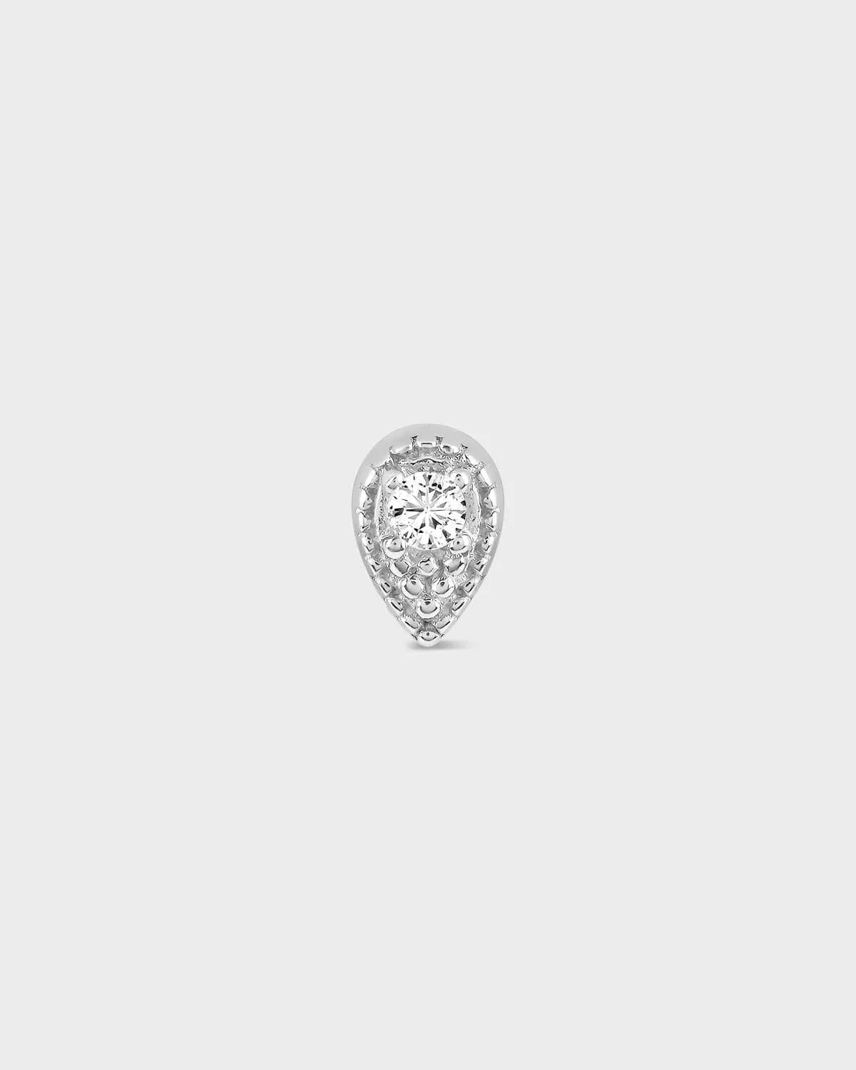 Teardrop-shaped diamond earring on a light gray background