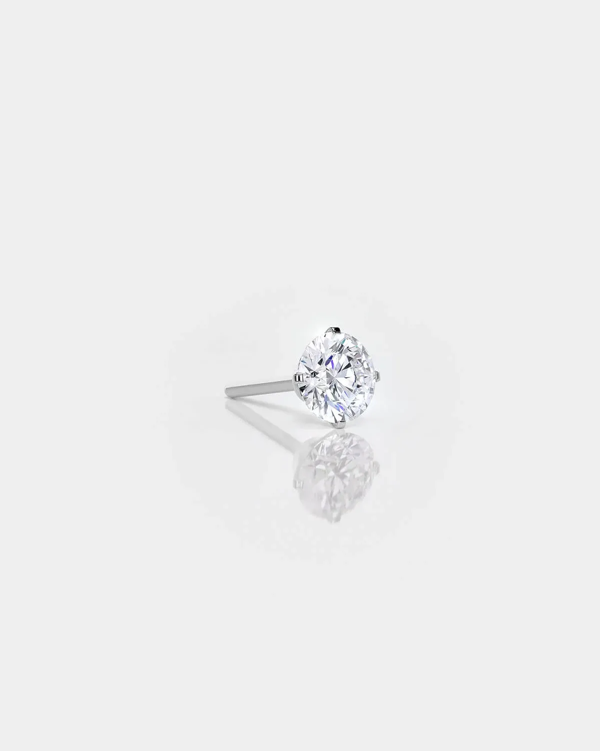 Diamond stud earring on a light gray background