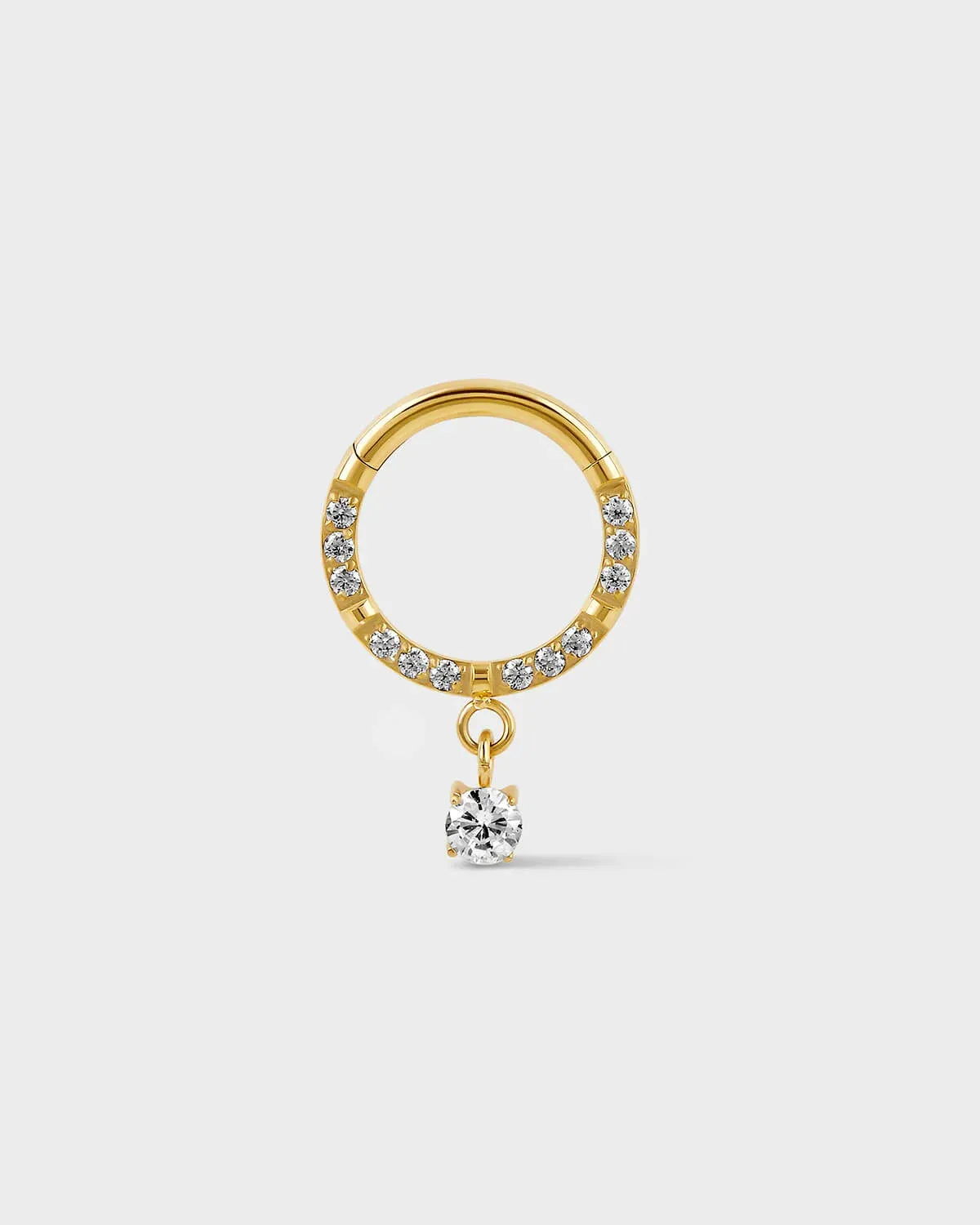 Semi pave hinged gold titanium daith septum ring with a solitaire drop charm sat on a light gray background.