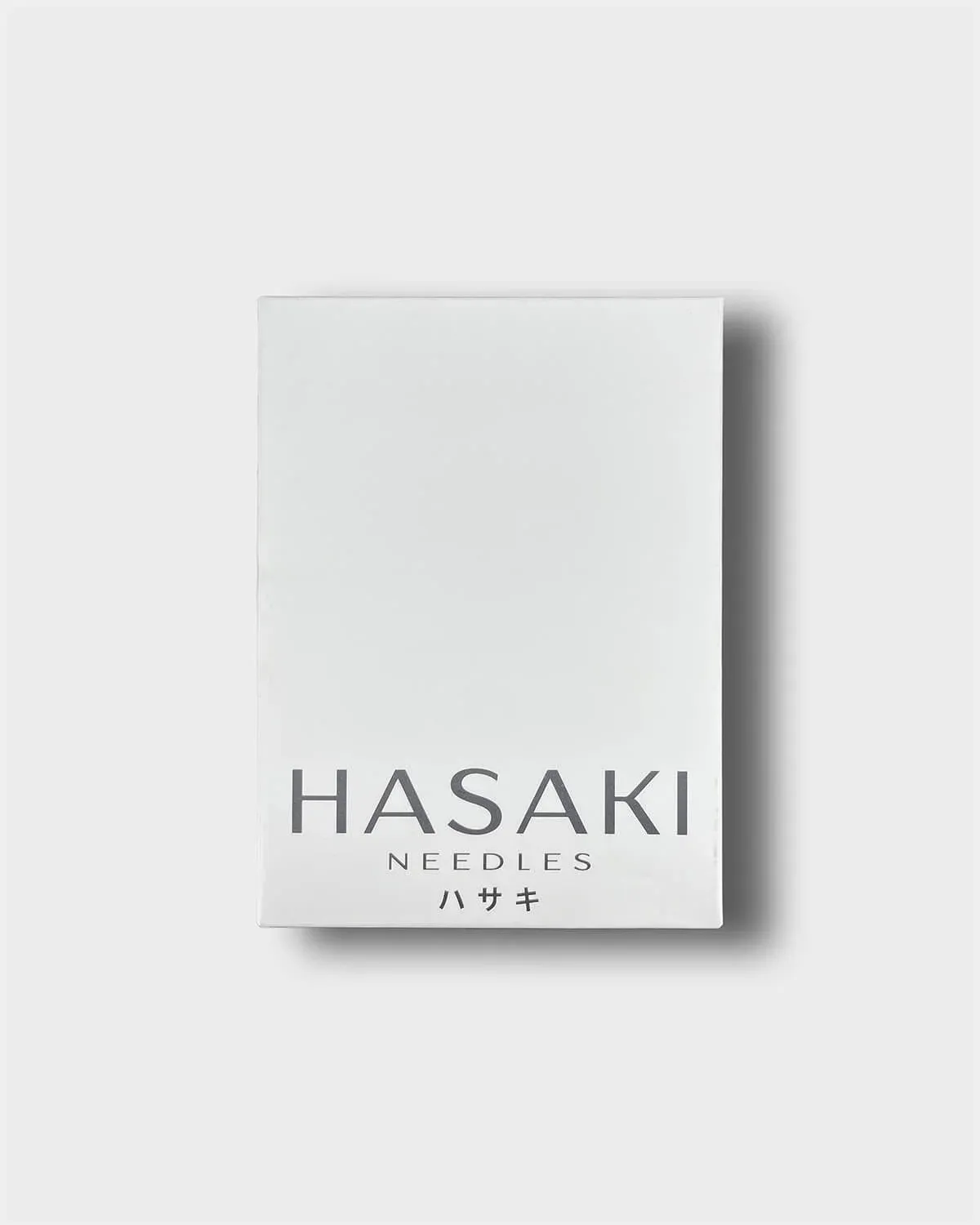 Outer box of hasaki piercing needles on a light grey background