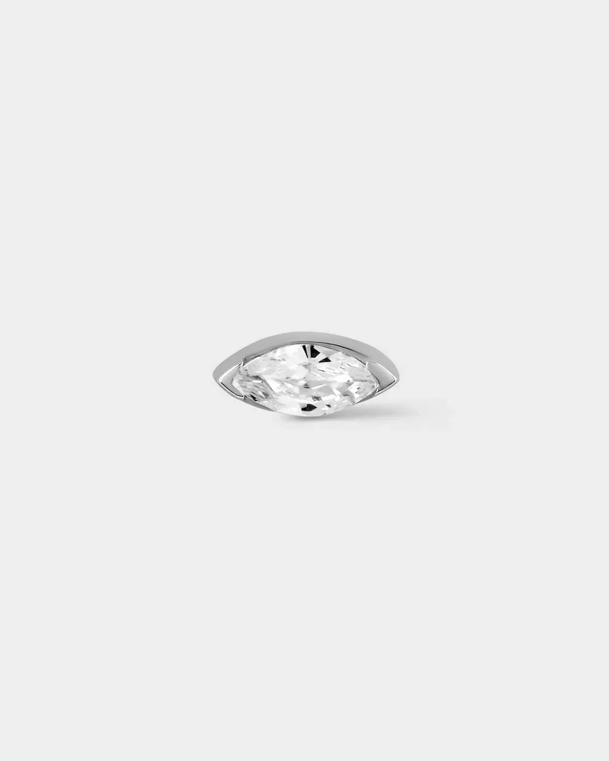 White gold earring with marquise gem on light grey background