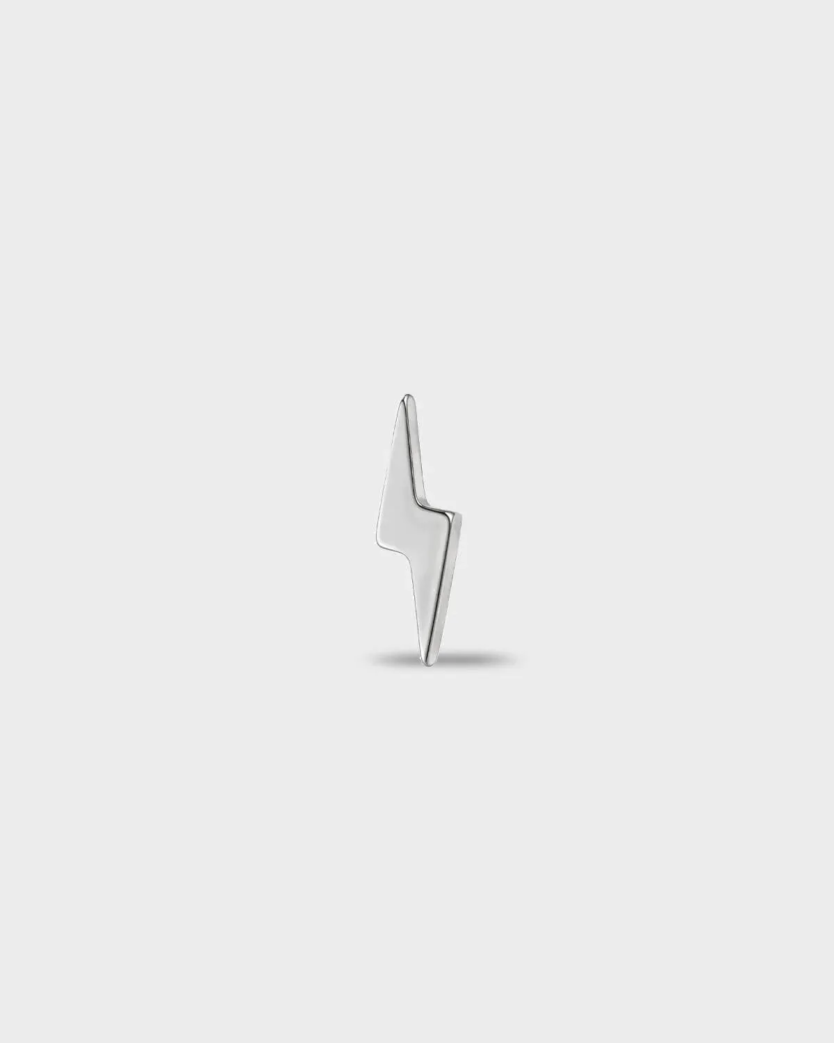 Polished titanium earring with a polished lightning bolt shape, on a light gray background.