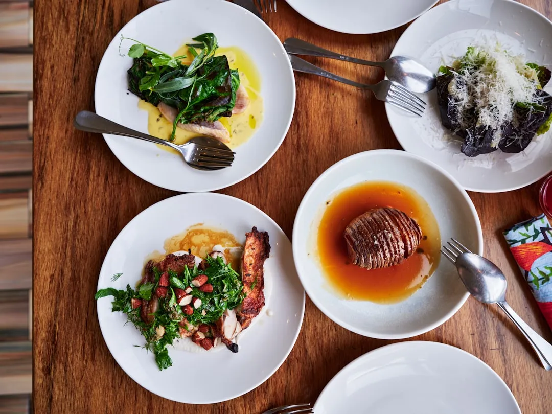 Four plates of delicious food arranged on a table.