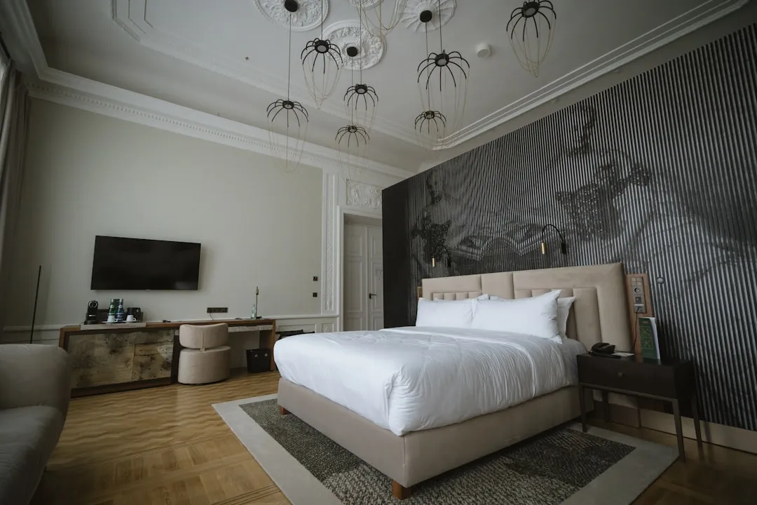 a [UNK] with a large bed and a tv on the wall