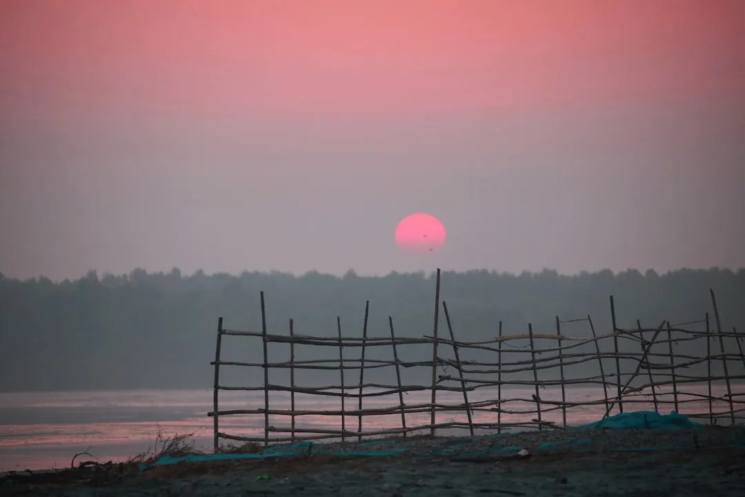 The sun is setting over a body of water