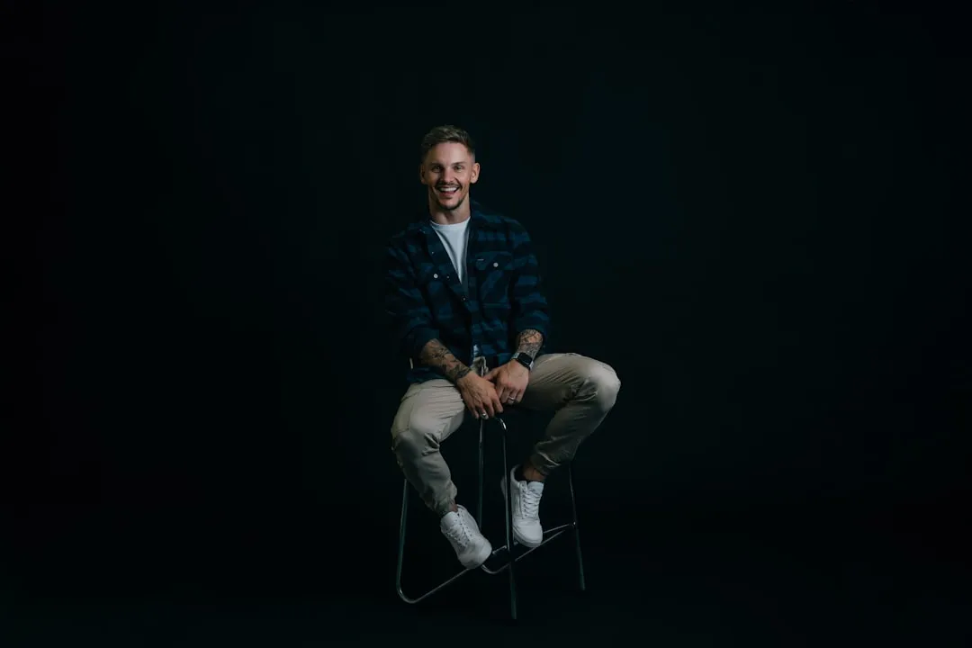 A man sitting on a chair in the dark